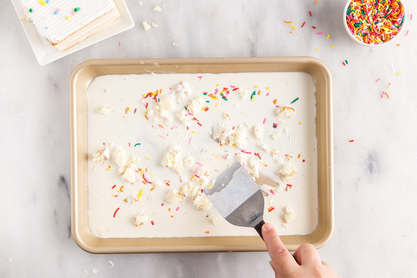 mixing birthday cake ice cream on a pan