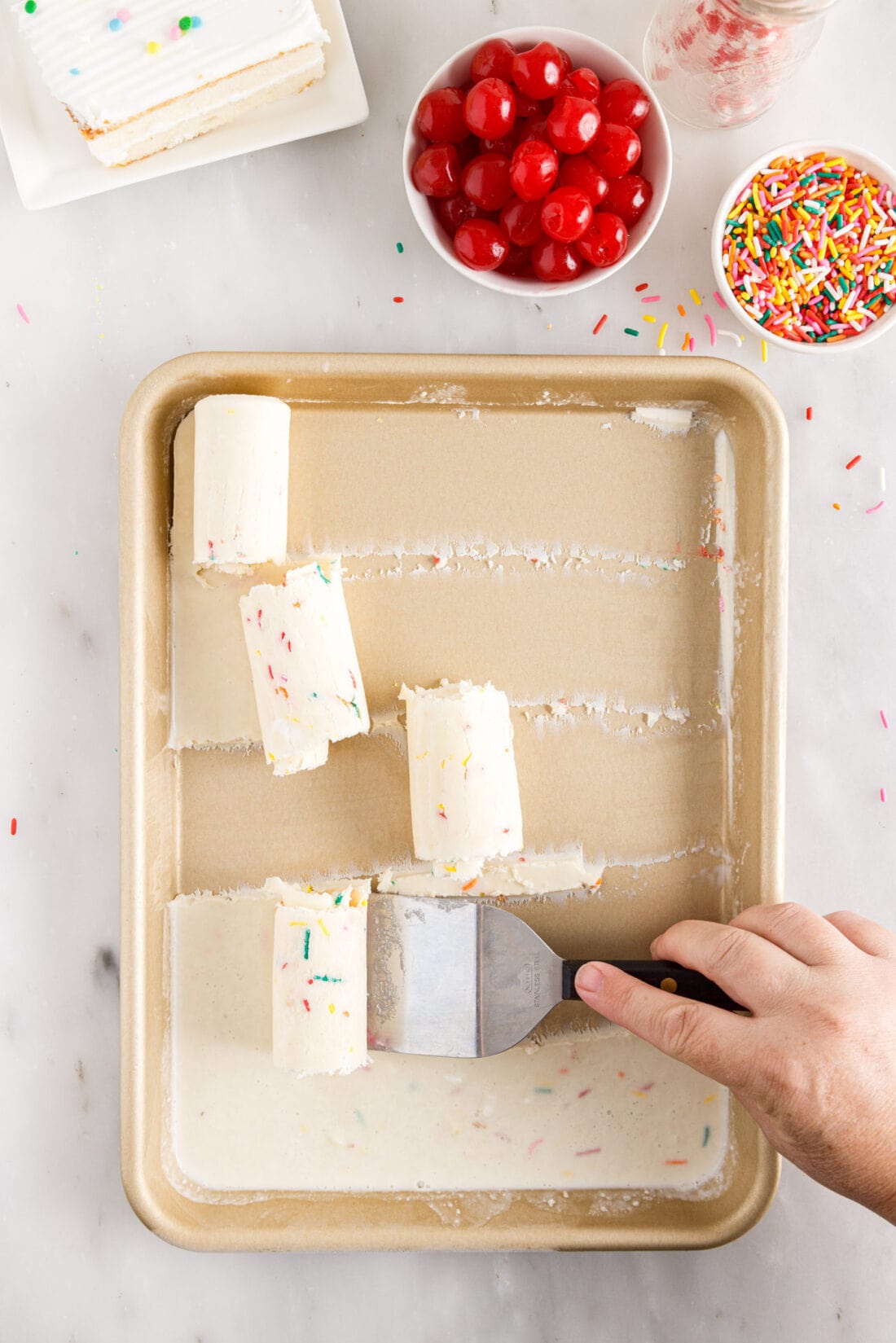 scraping Birthday Cake Rolled Ice Cream out of pan