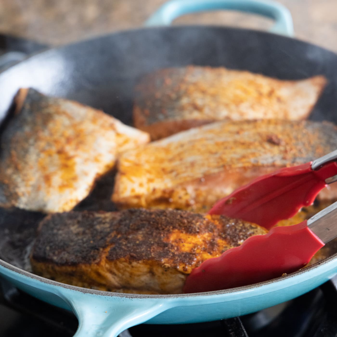 blackened salmon cooked in a skillet