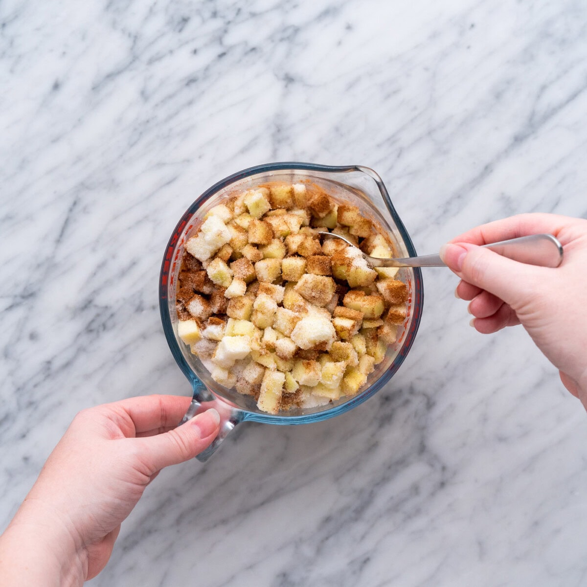 mixing chopped apples with spices and sugar