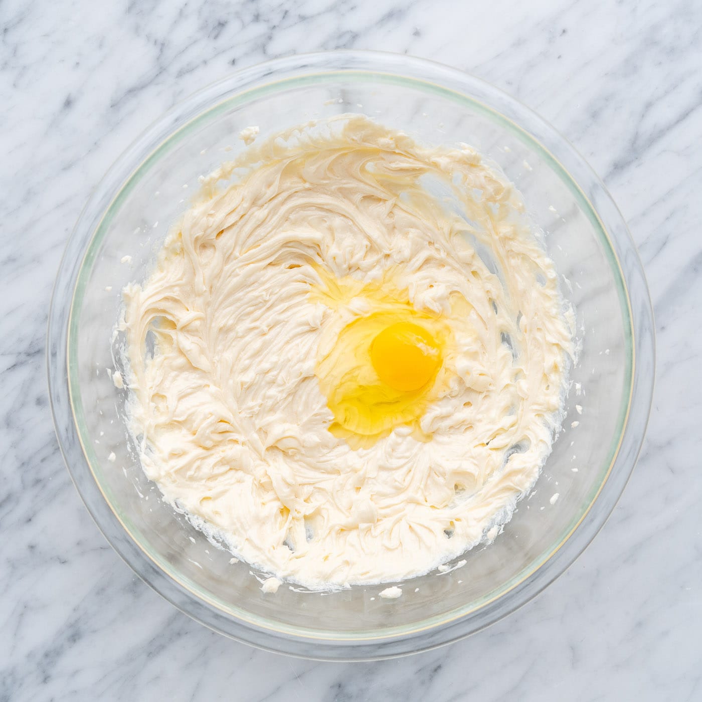 beating eggs into cream cheese mixture