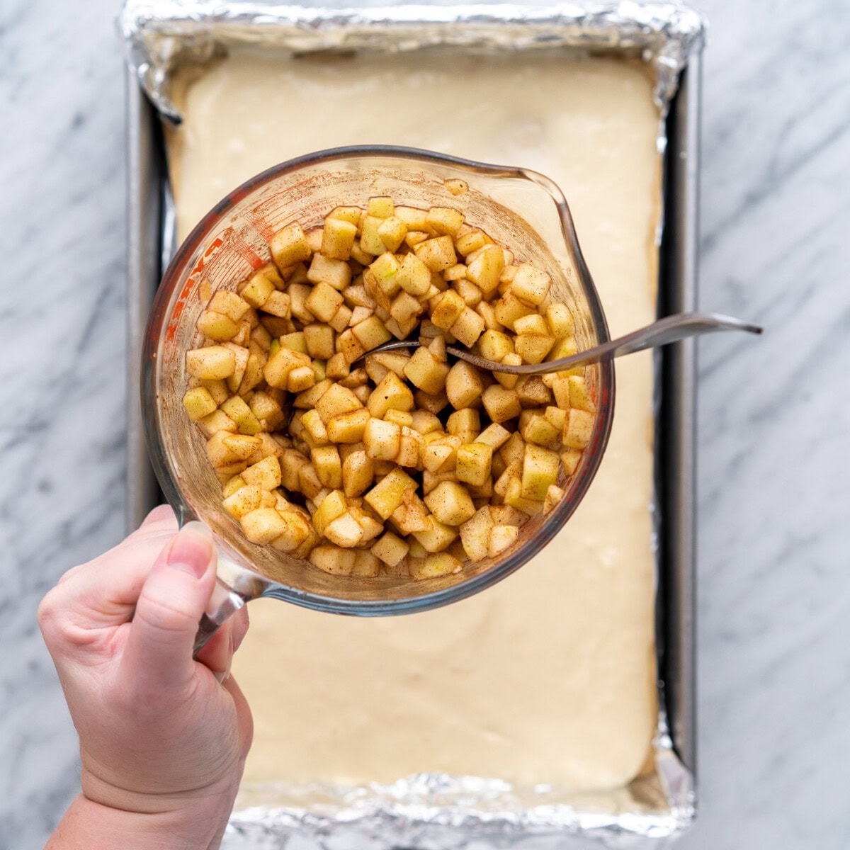 cinnamon nutmeg spiced apples over the top of cheesecake