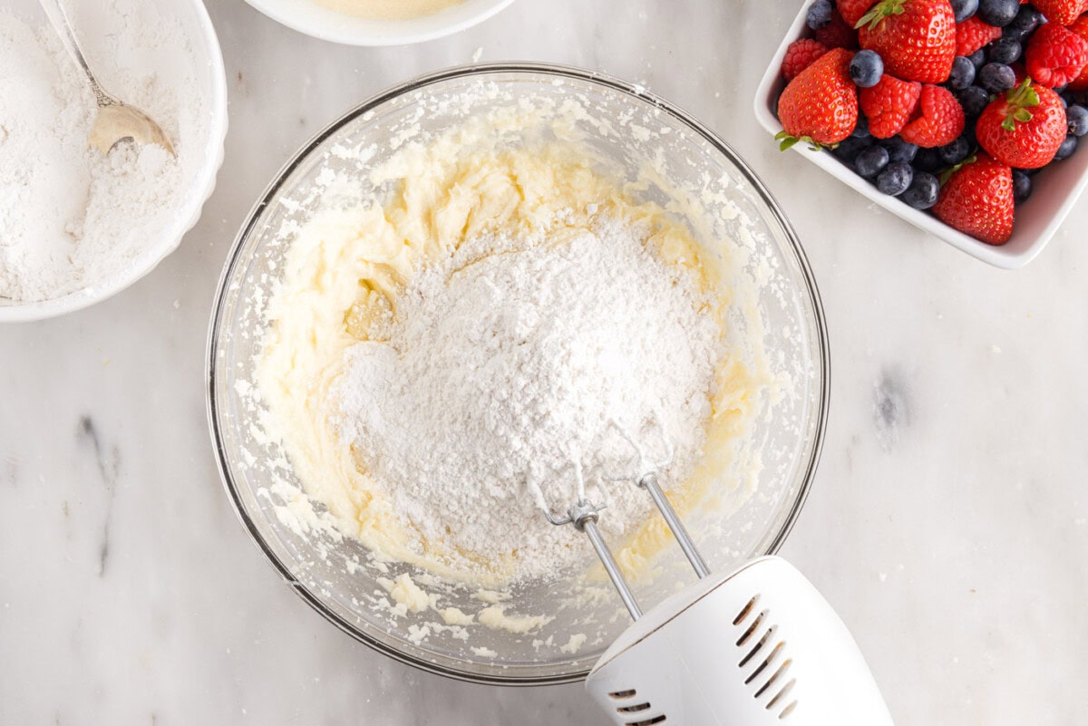 adding dry ingredients to wet ingredients for chantilly cake