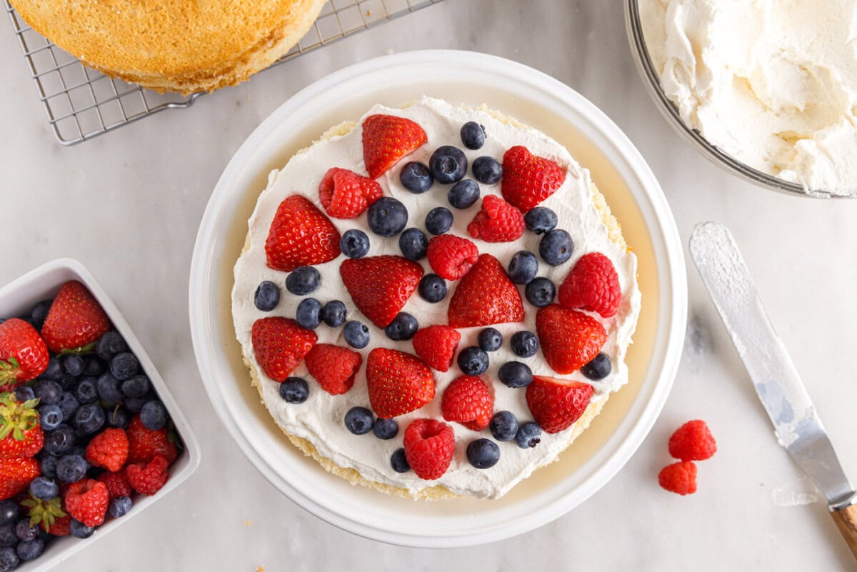 strawberries and blueberries layered on chantilly cake