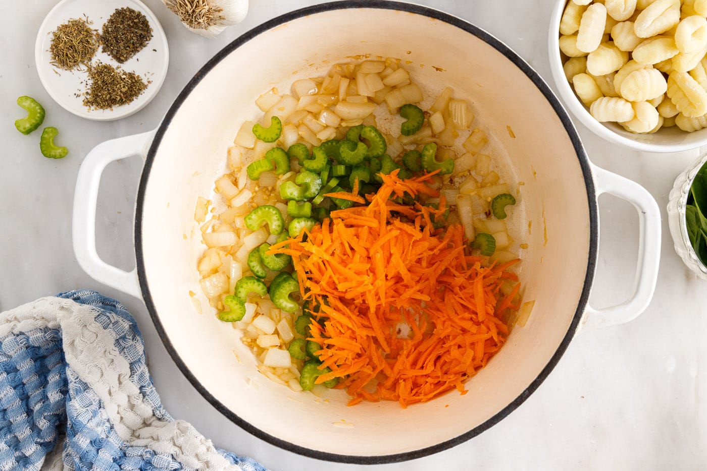 shredded carrots, celery, onion, and garlic in a stockpot