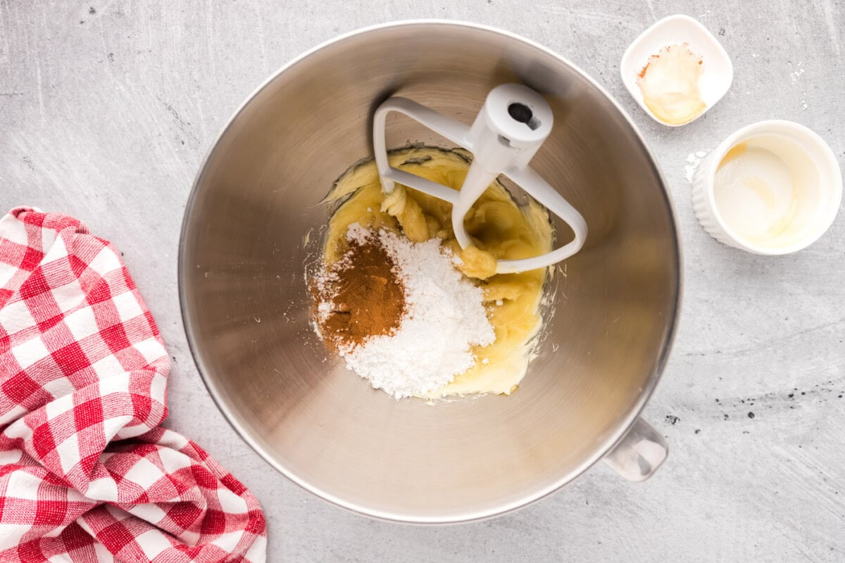 mixing powdered sugar and cinnamon into honey butter mixture