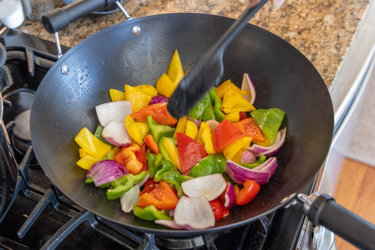 sauteeing veggies in a wok