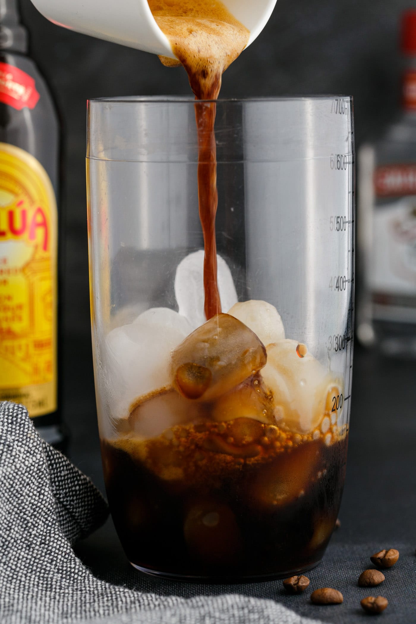 pouring espresso into cocktail shaker