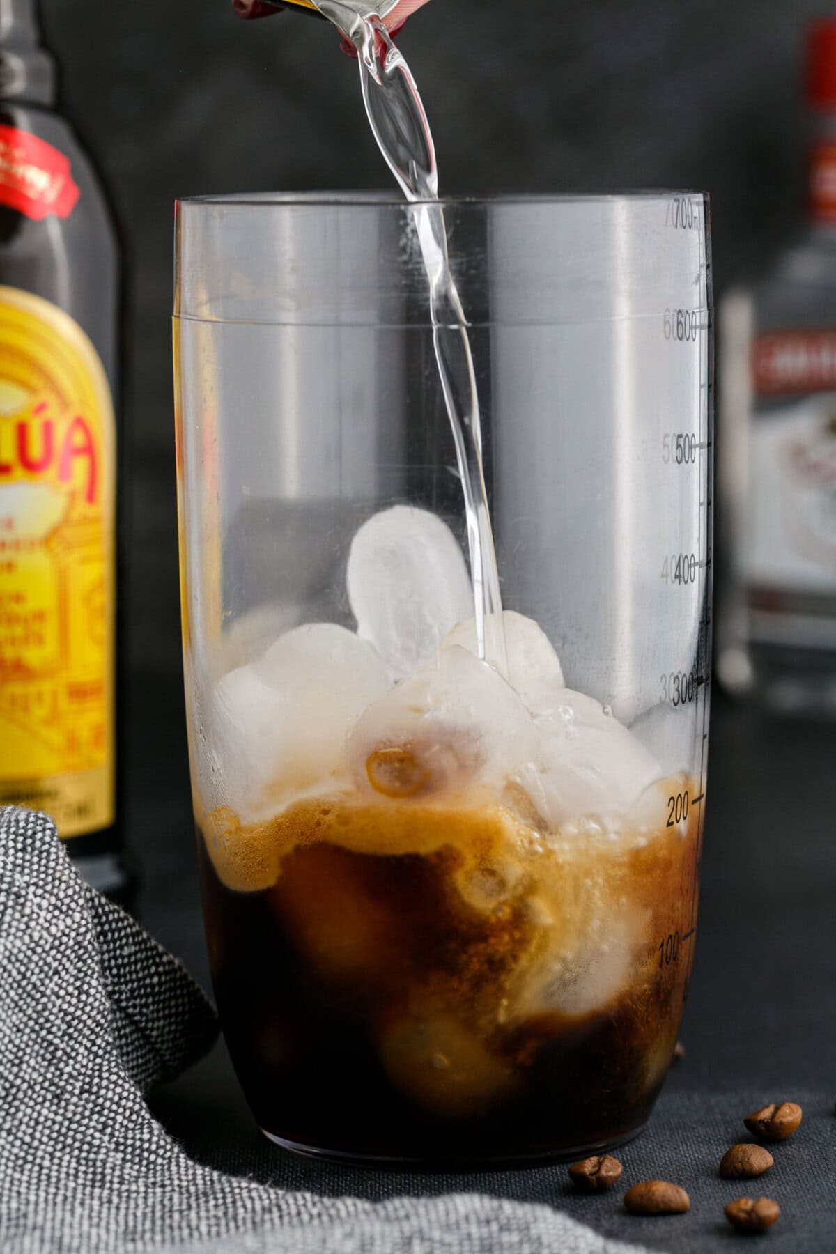 pouring vodka into espresso martini