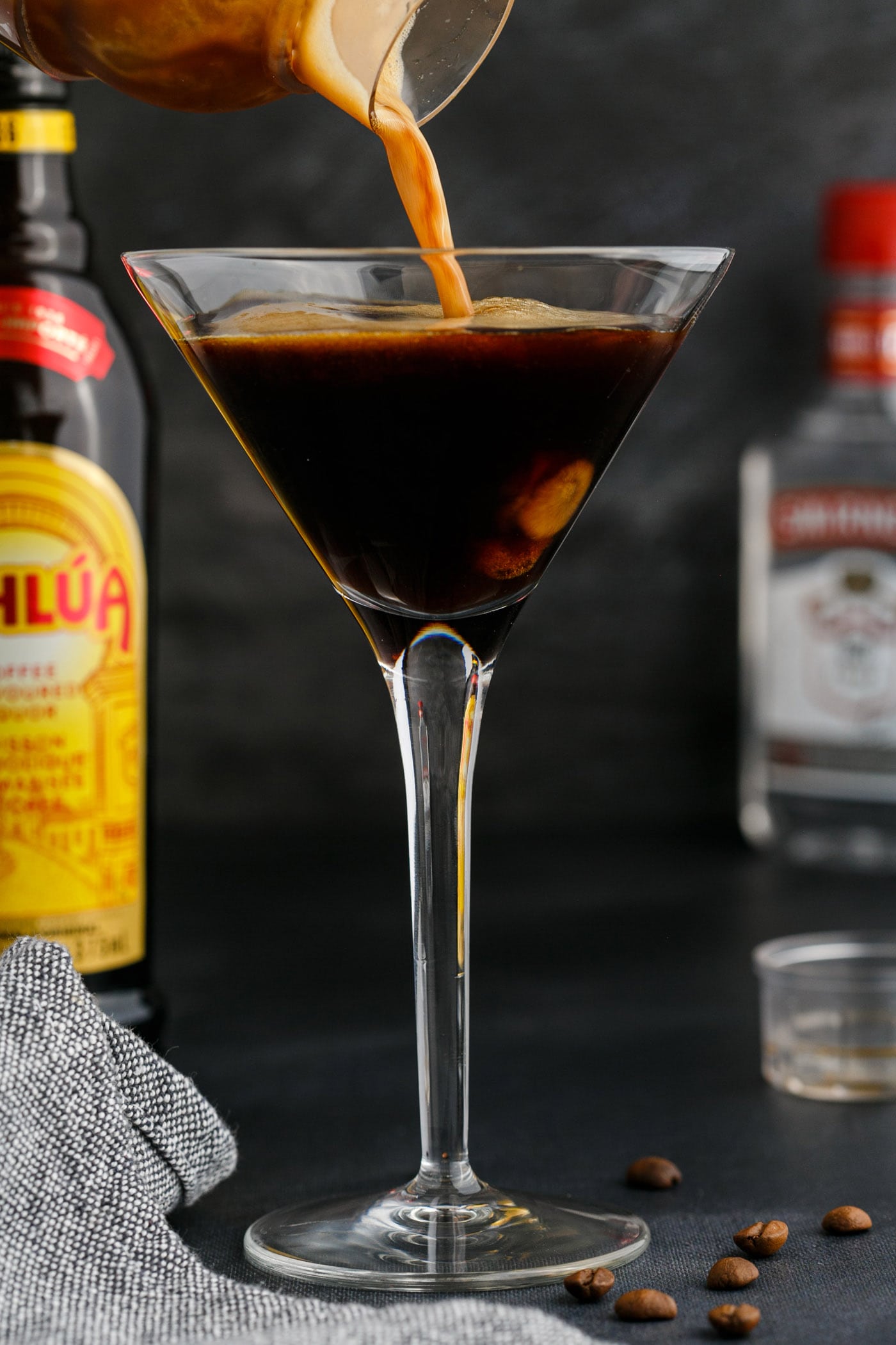straining espresso martini into a glass