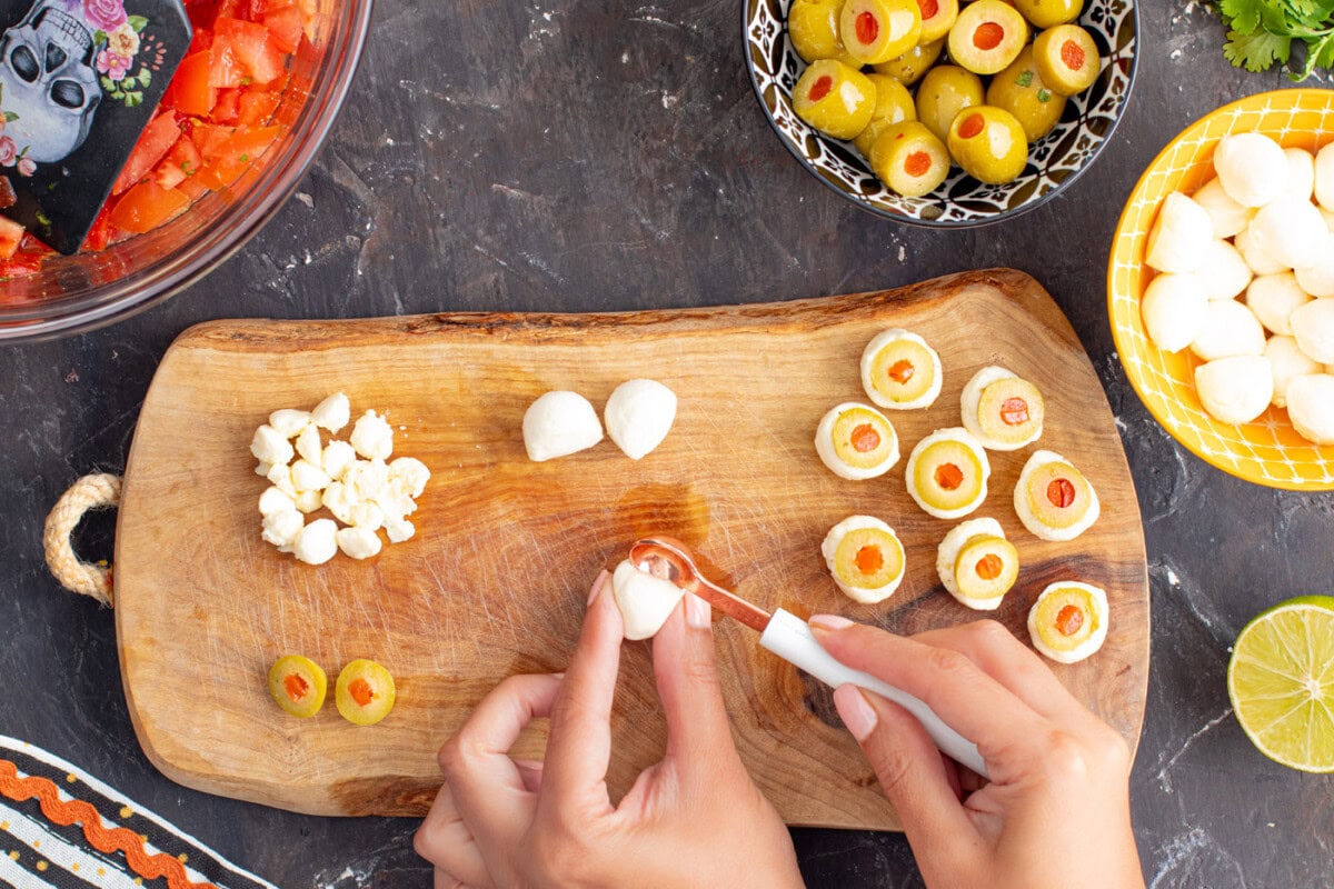scooping a hole into the center of mozzarella ball