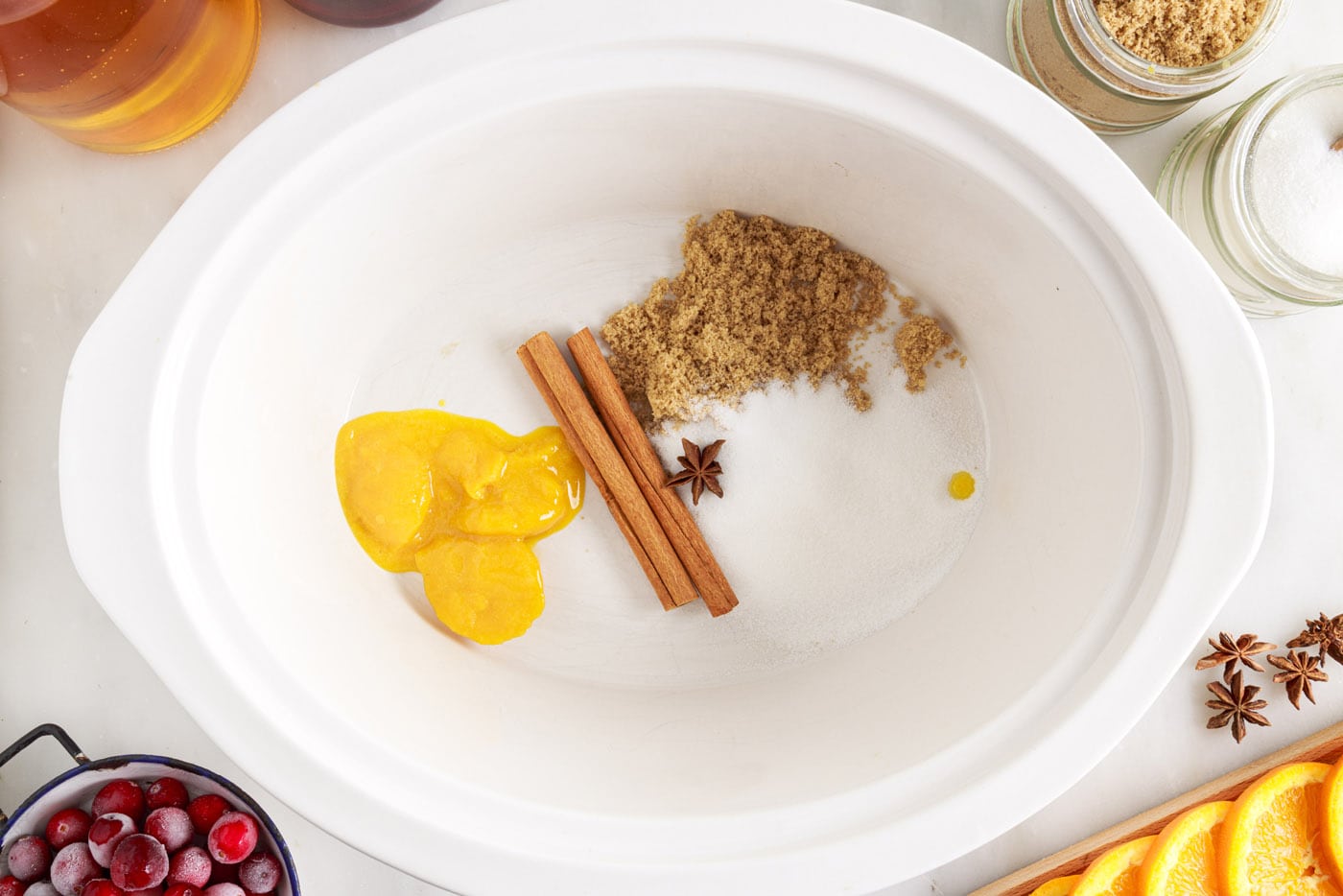 orange juice concentrate, sugars, cinnamon sticks and star anise in crockpot