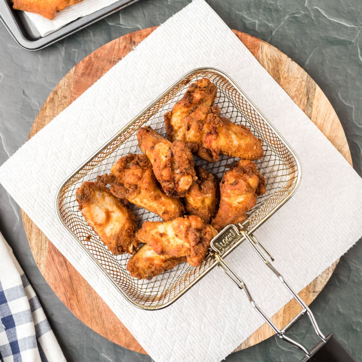 fried chicken wings in a deep fryer basket