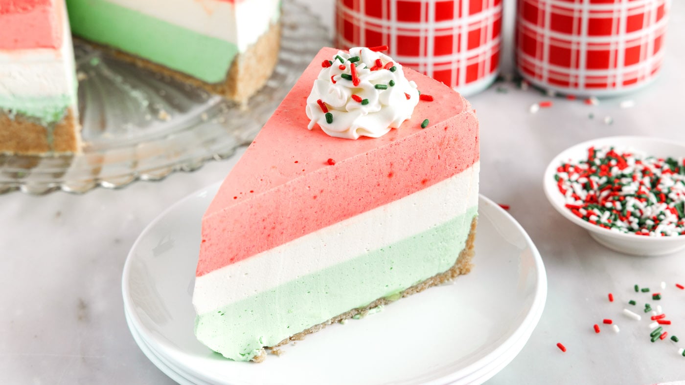 This layered jello pie combines cherry, lime, and lemon jello to make a festive Christmas pie. It's 