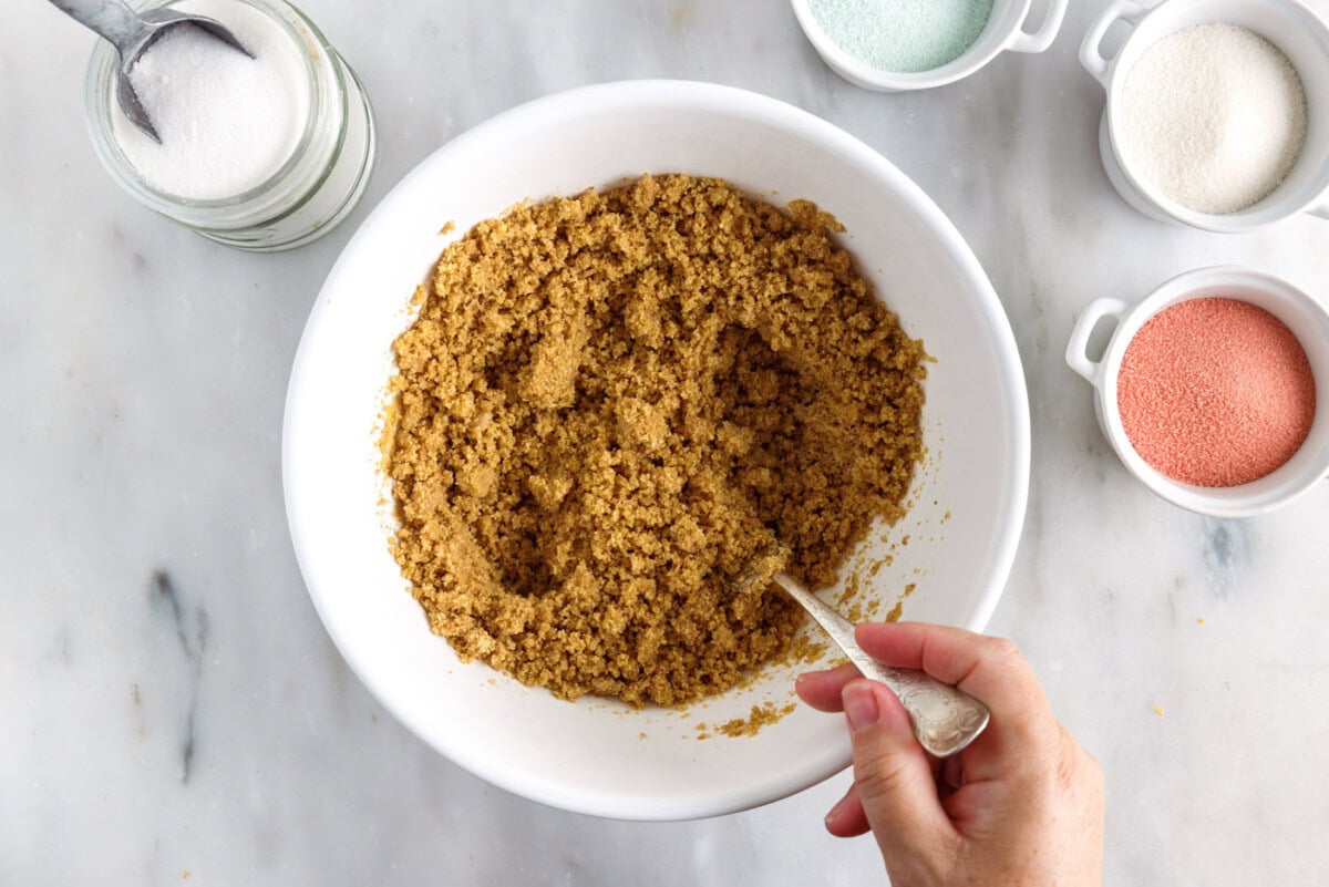 mixing graham cracker crumbs with butter and sugar
