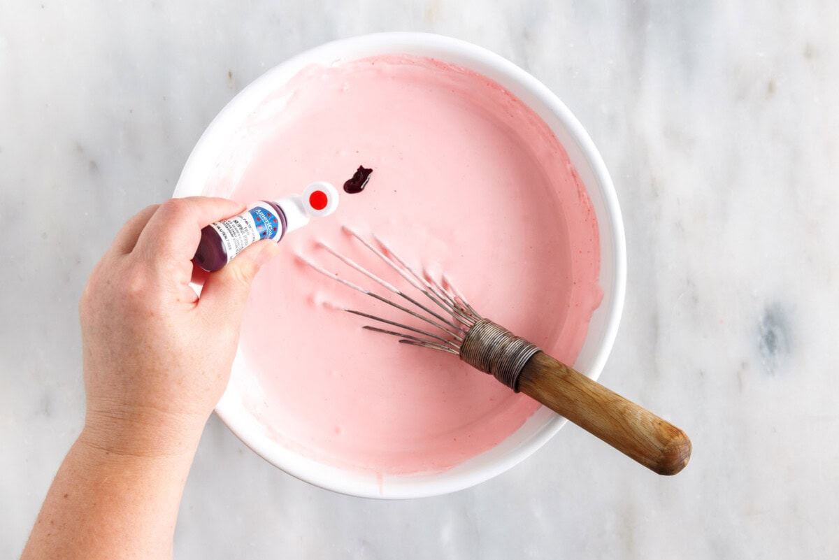 adding red food color to jello and whipped cream mixture