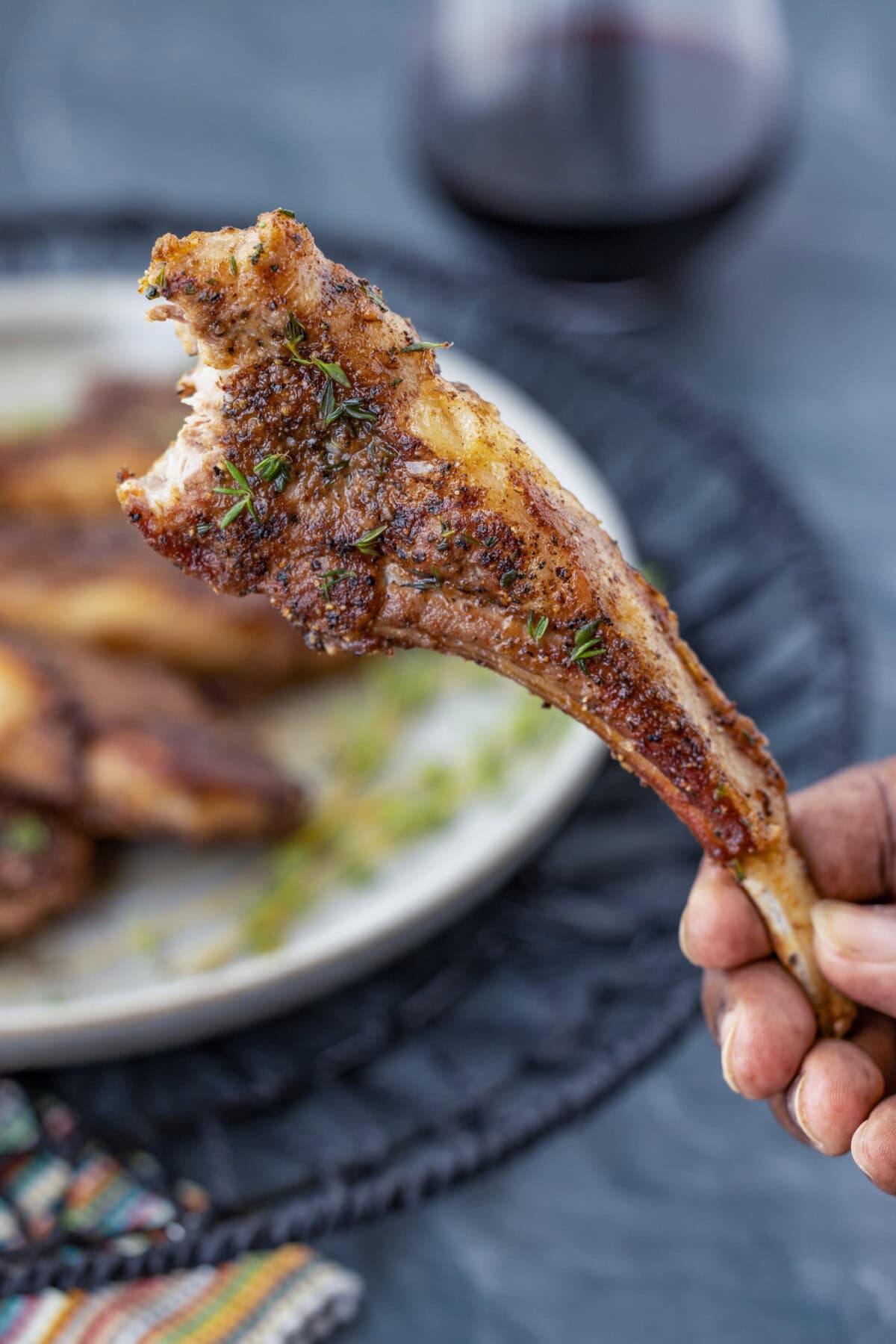 hand holding a Lollipop Lamb Chop