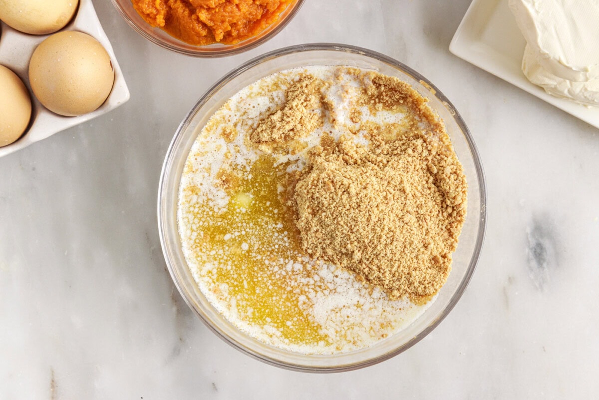 graham cracker crumbs, butter, and sugar in a bowl