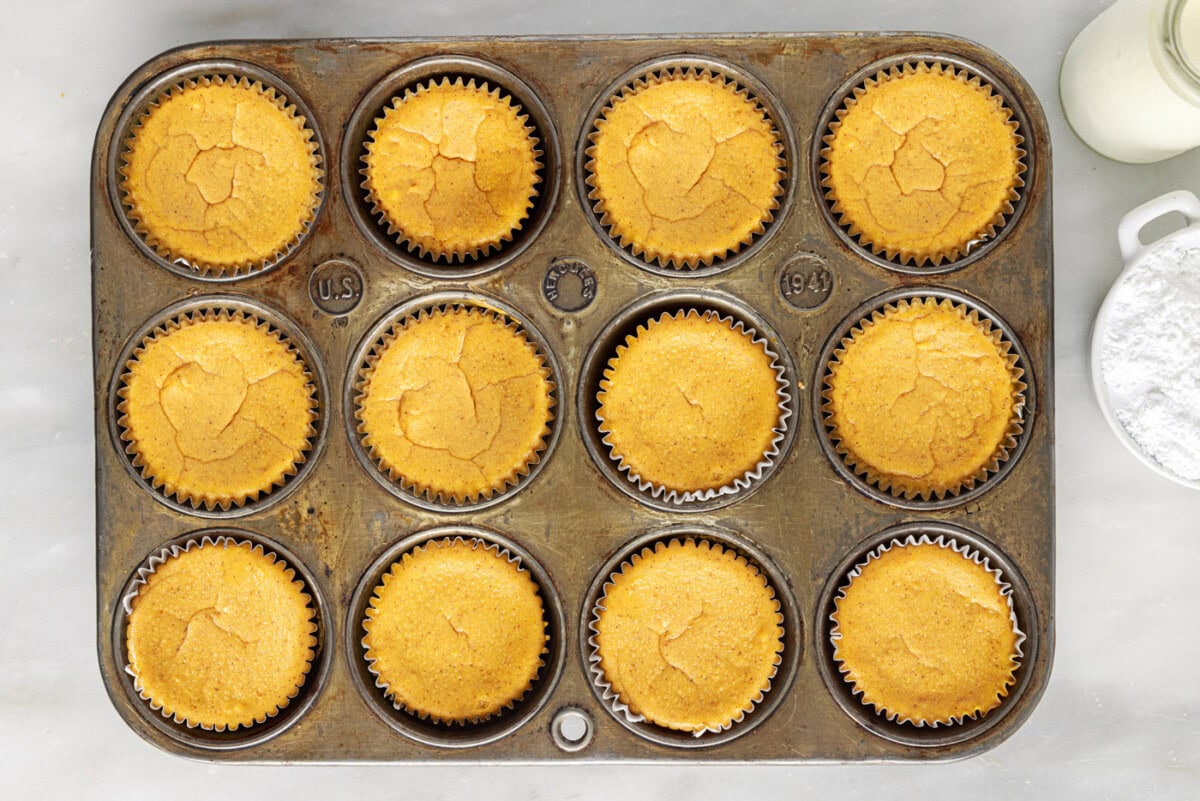 mini pumpkin cheesecakes in a muffin tin