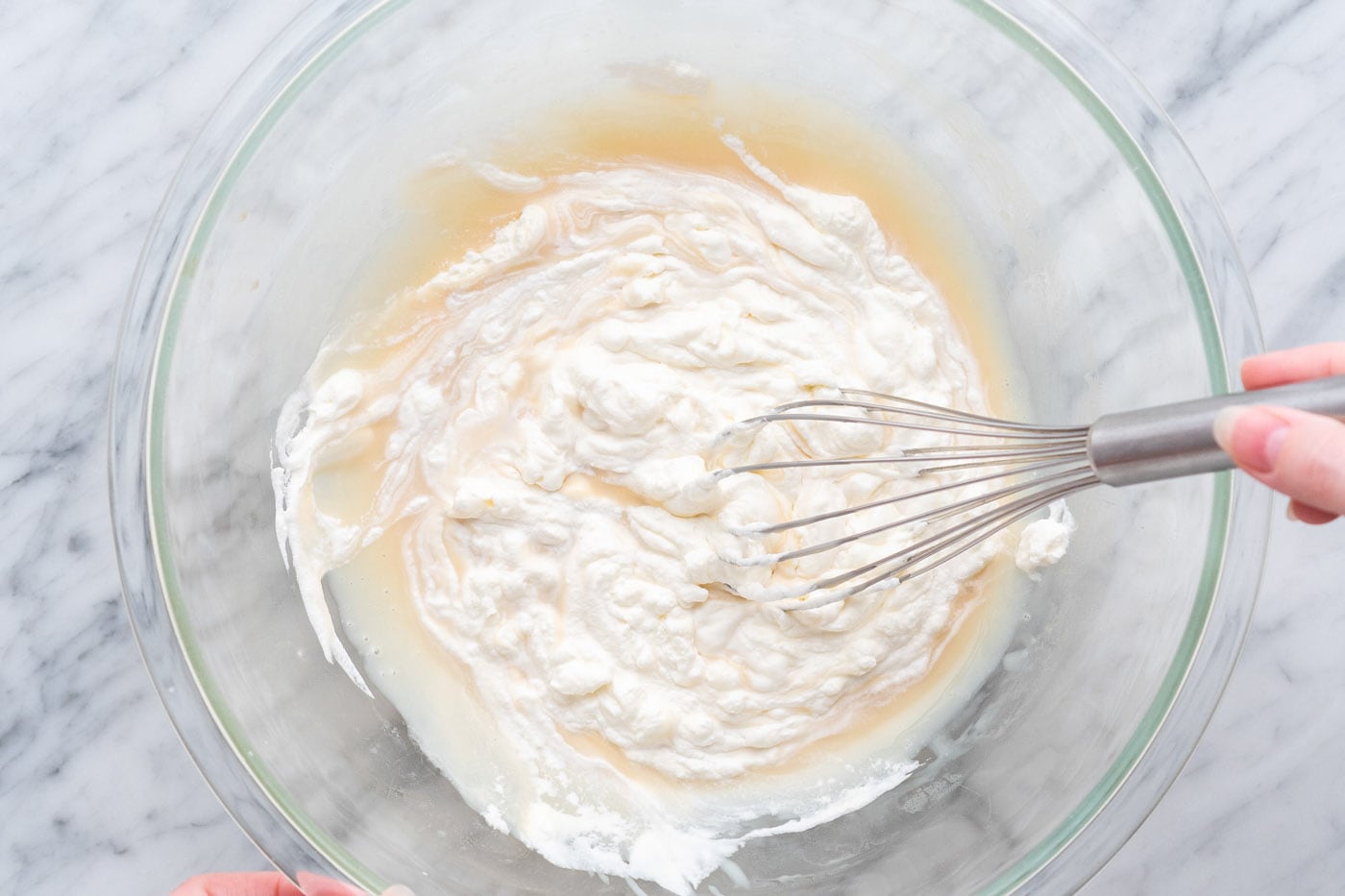 whisking no churn ice cream together in a bowl
