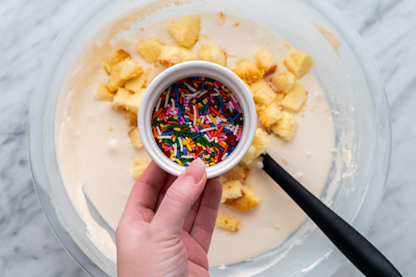 sprinkles and cake pieces added to no churn ice cream