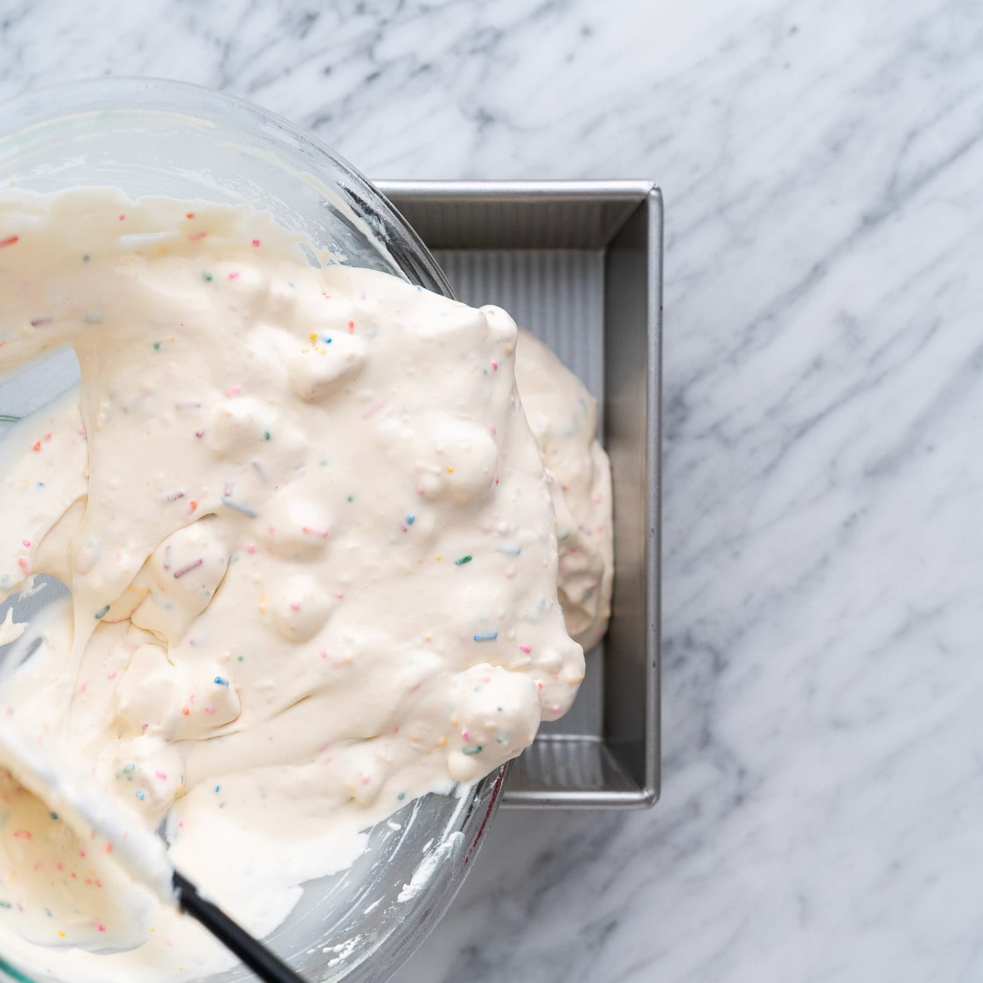 pouring birthday cake ice cream into a loaf pan