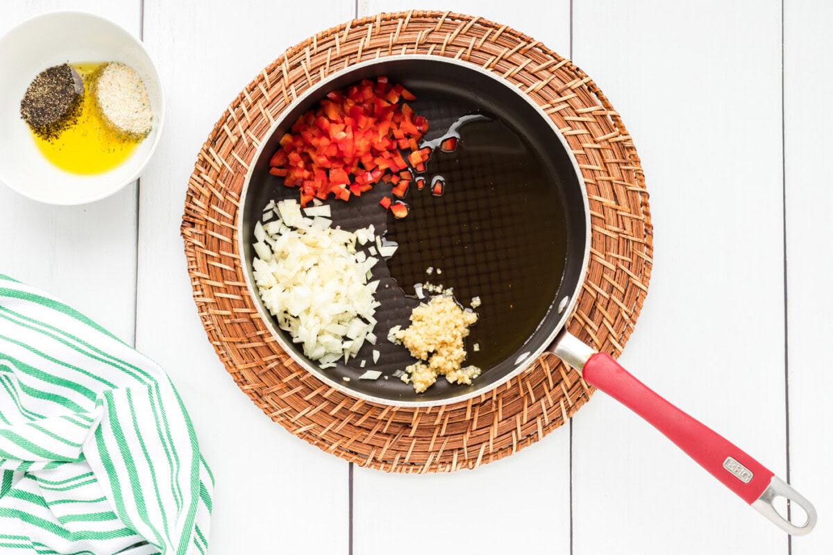 red bell pepper, garlic, and onion in a skillet witholive oil