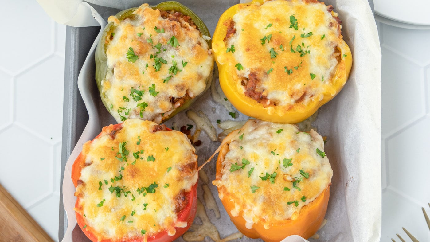 Colorful stuffed peppers are made with lean ground beef, sweet Italian sausage, white rice, and shre
