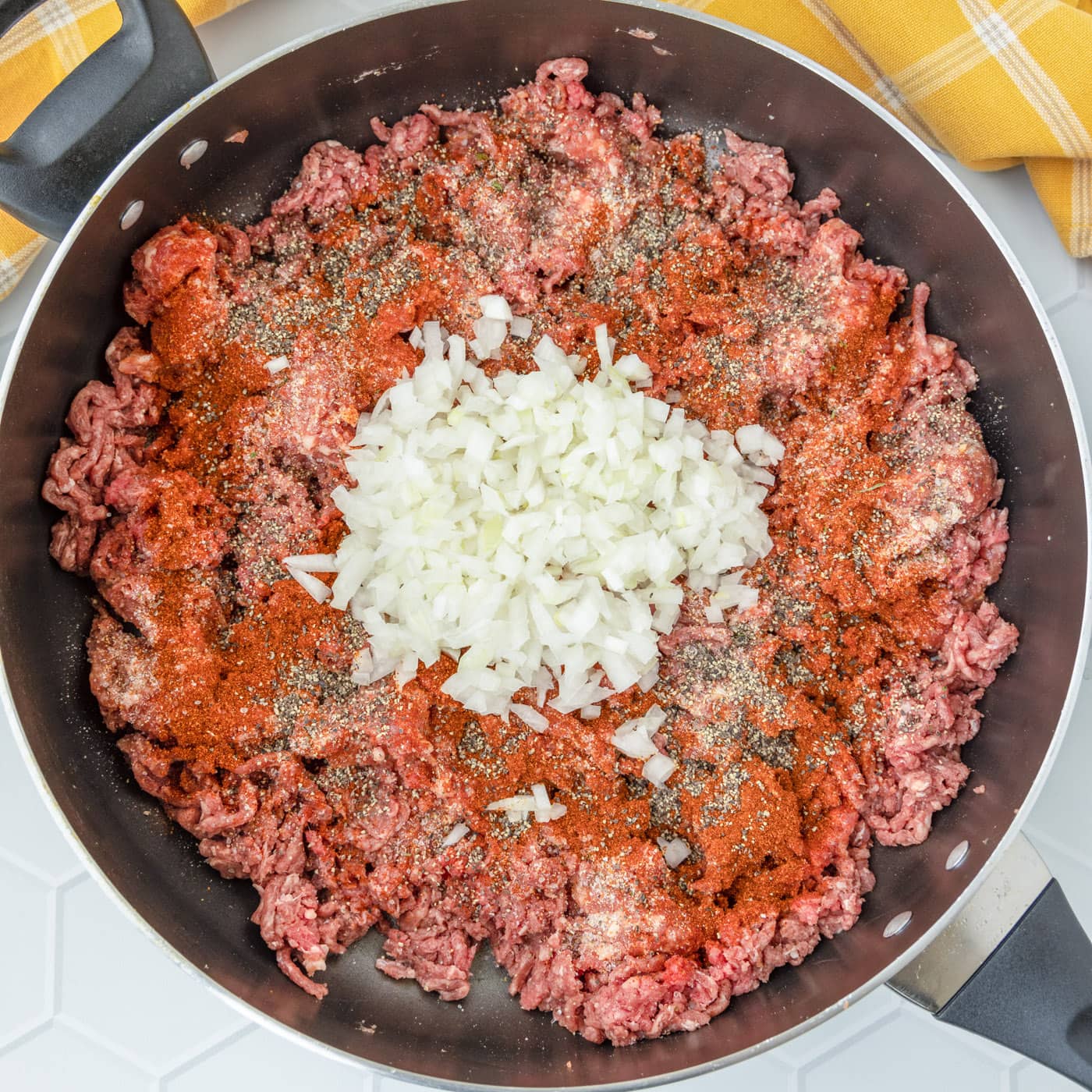 italian sausage, ground beef, onions, and seasoning browning in a skillet
