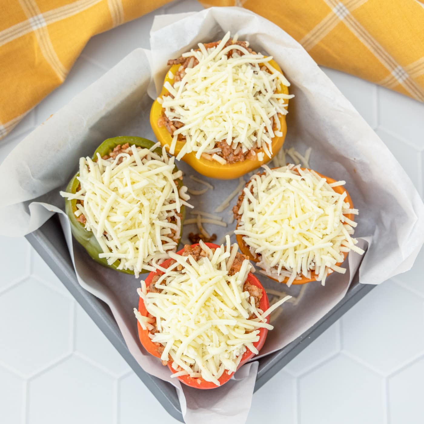 stuffed peppers with cheese in a baking dish