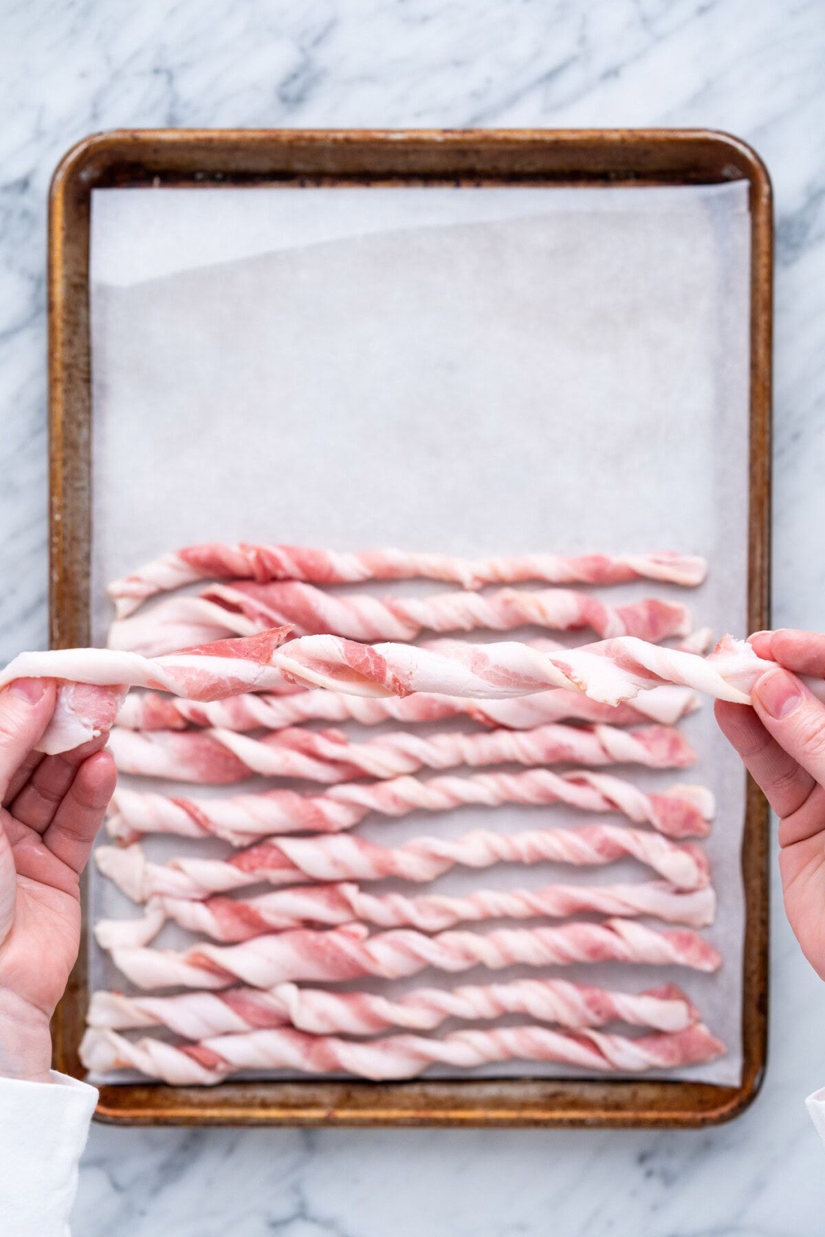 twisted bacon over a baking tray