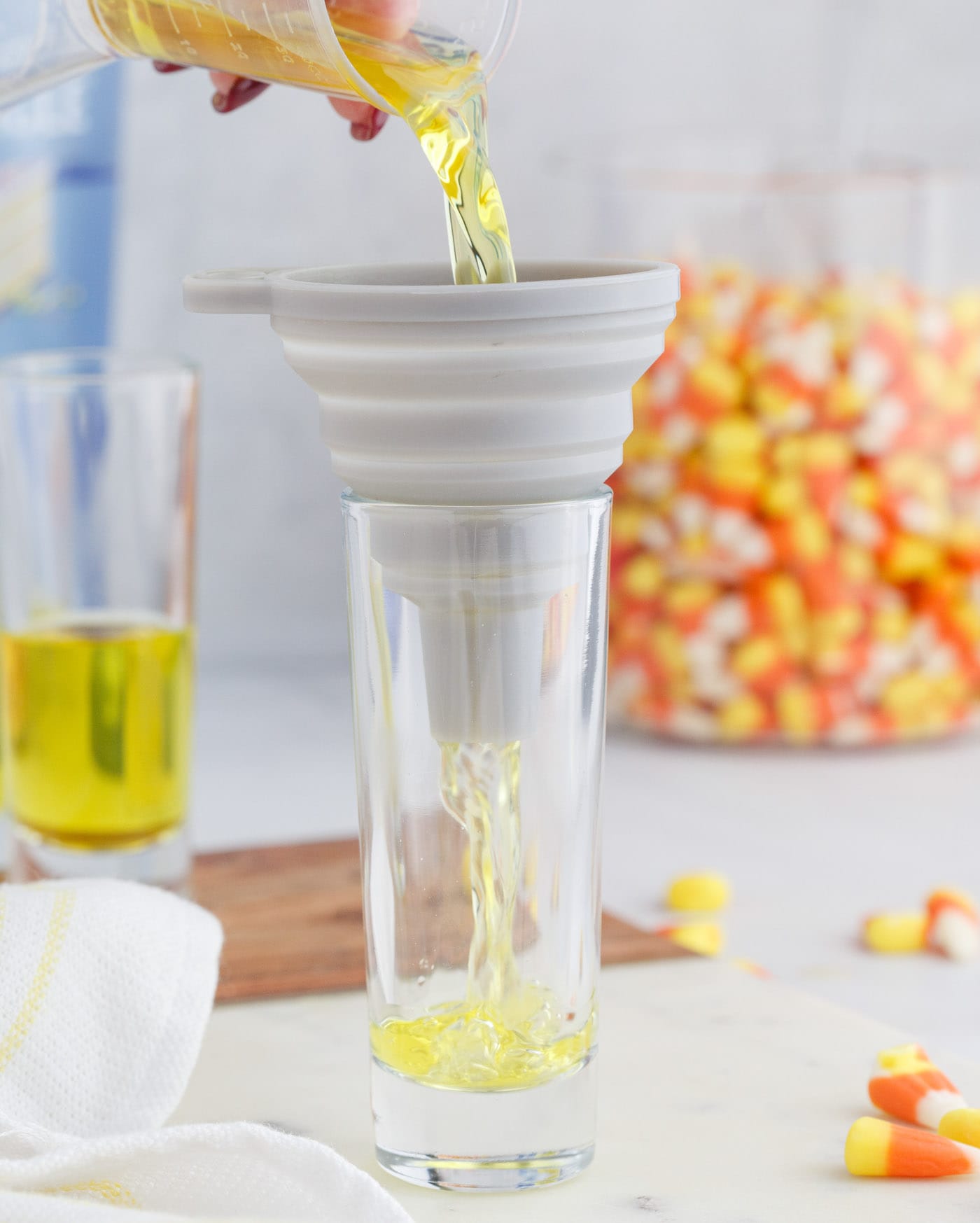 pouring jello mix into shot glass
