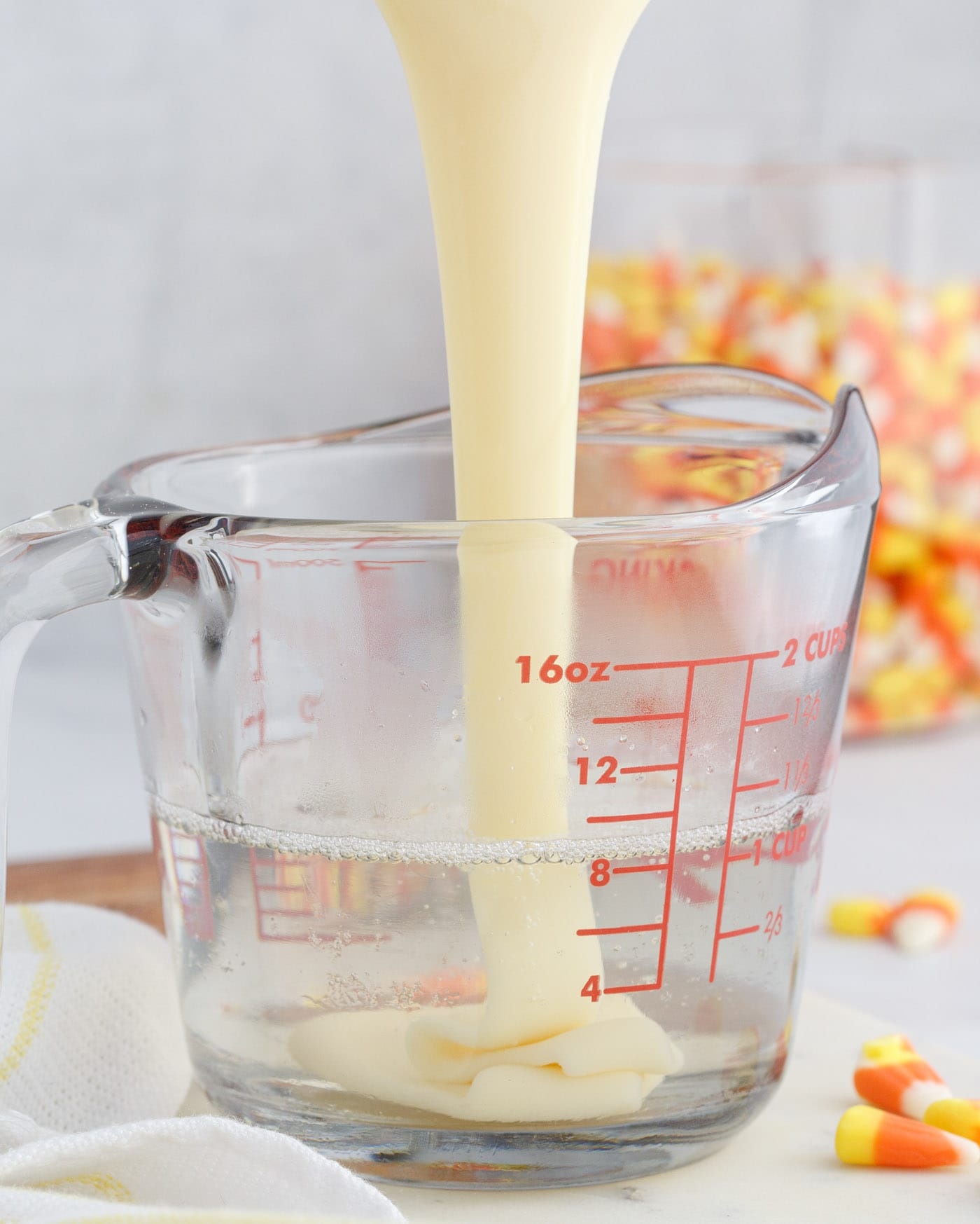 pouring sweetened condensed milk into unflavored gelatin