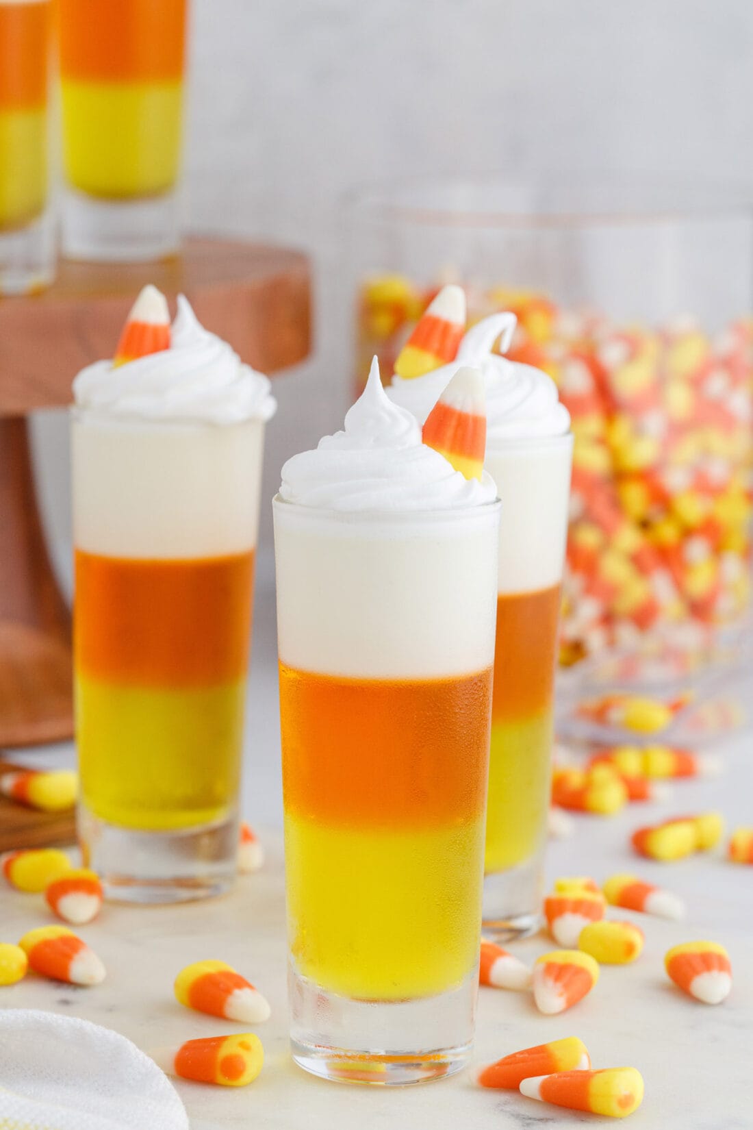 Candy Corn Jello Shots with candy corn in background
