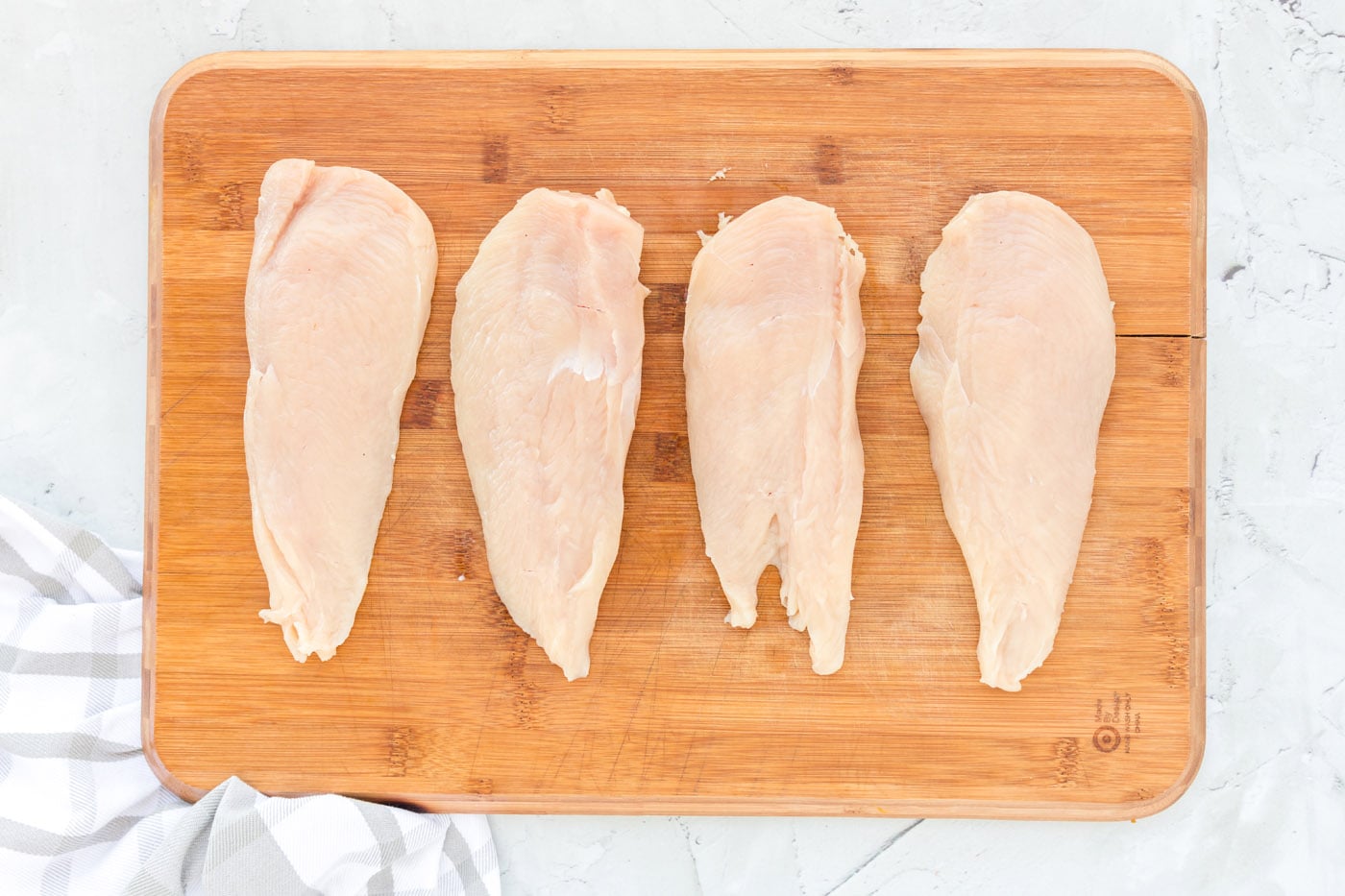 chicken cutlets on a cutting board