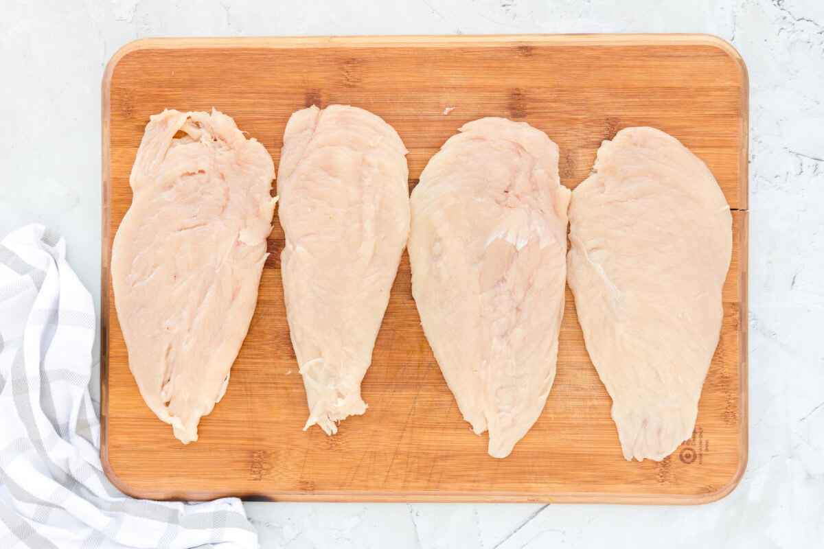 pounded chicken cutlets on a cutting board