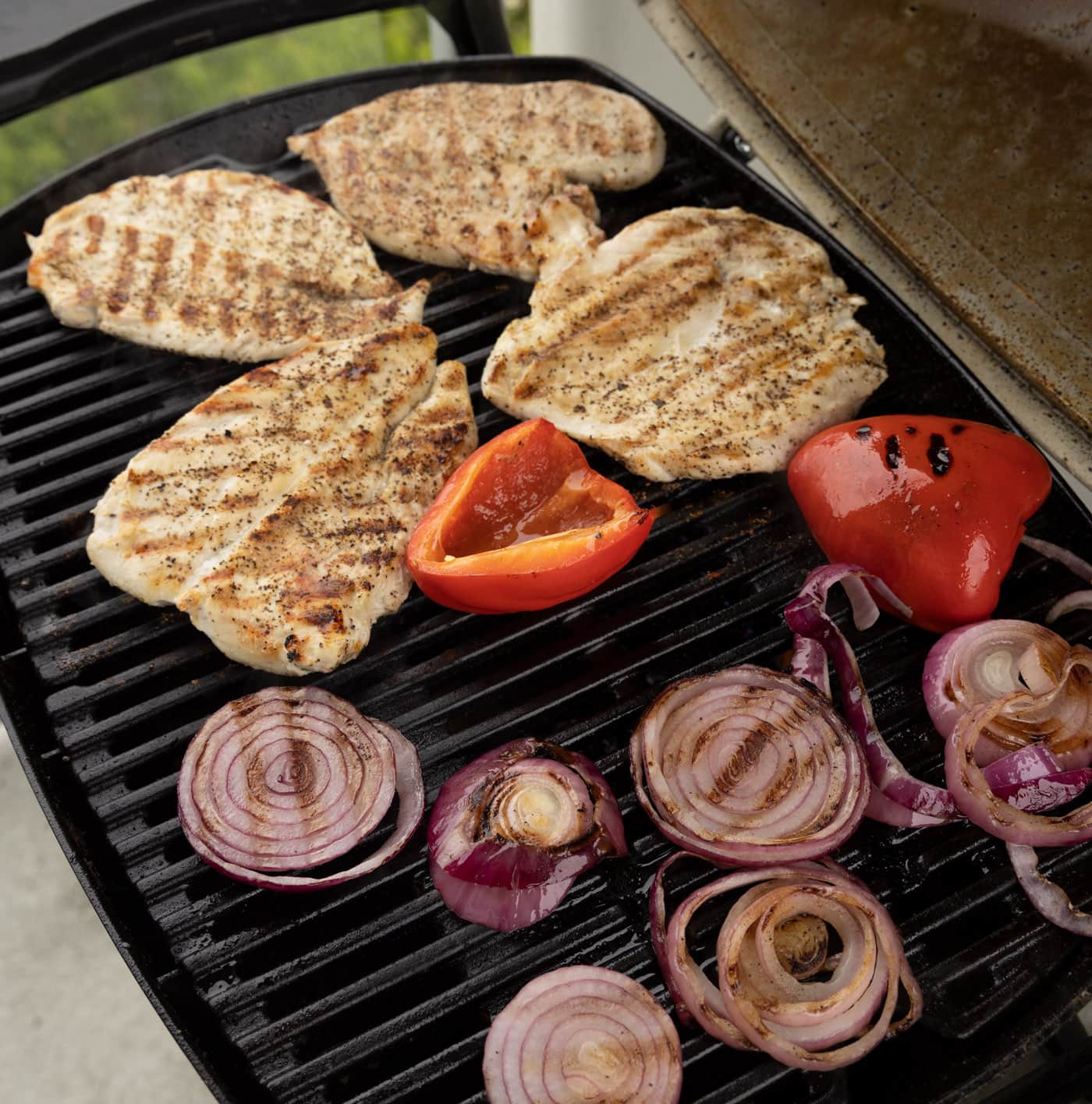 chicken, bell pepper, and onion on the grill