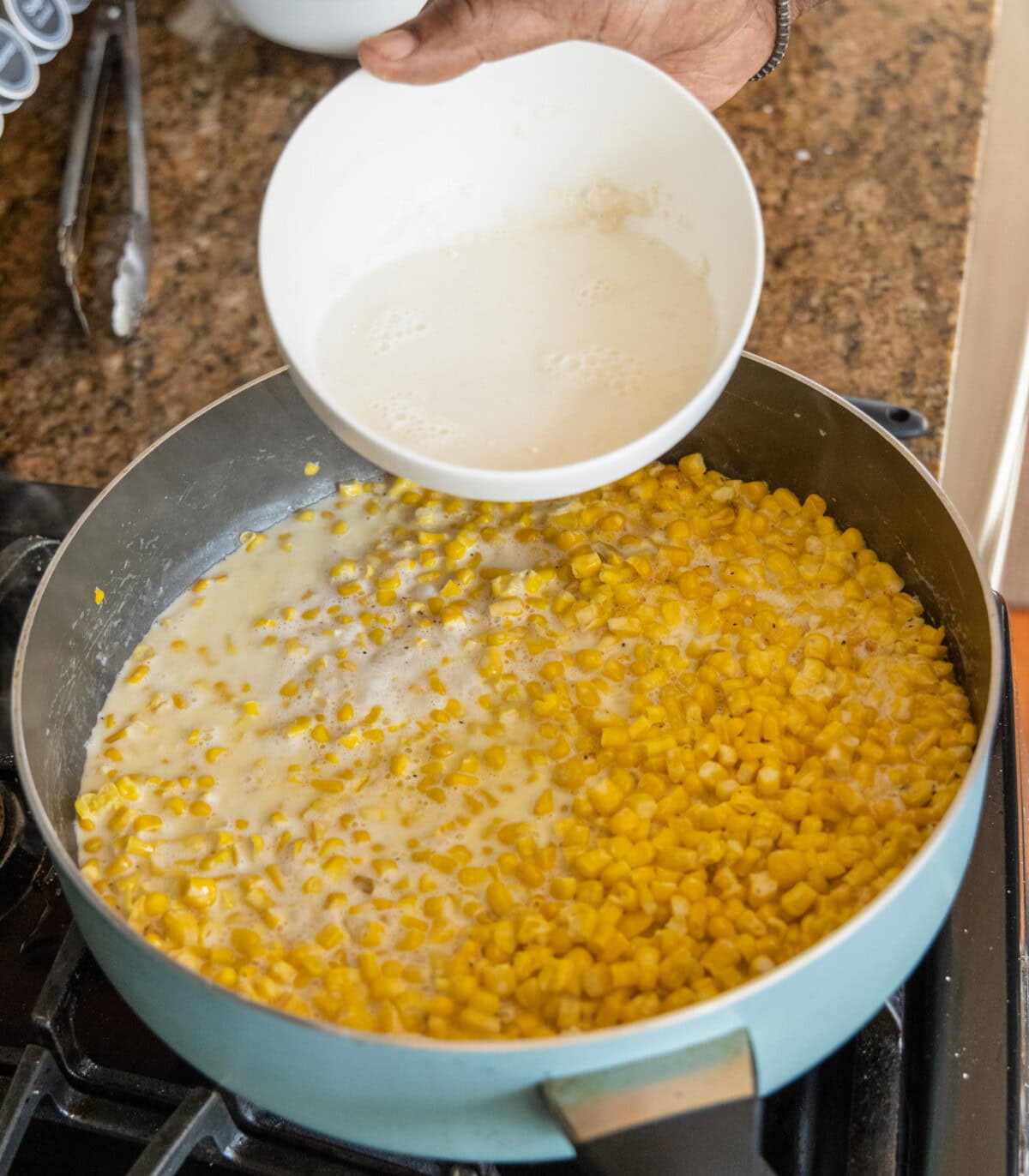 adding milk and flour mixture to creamed corn