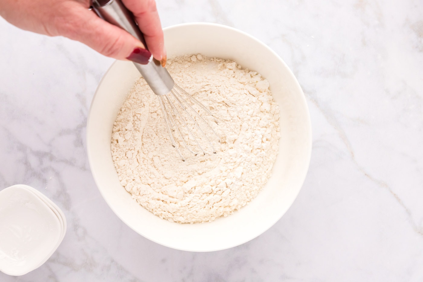 whisking flour, salt, baking soda, and cornstarch in a bowl