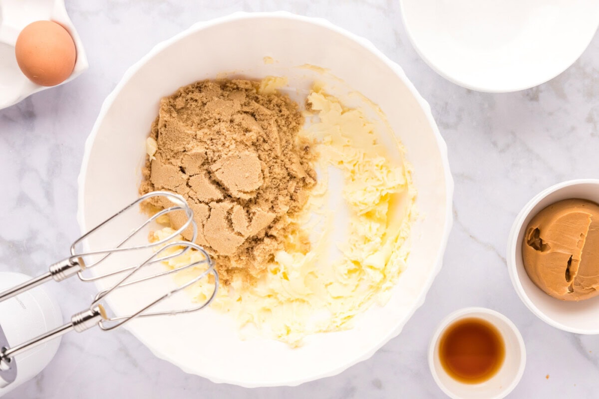 using a mixer to incorporate sugars with butter
