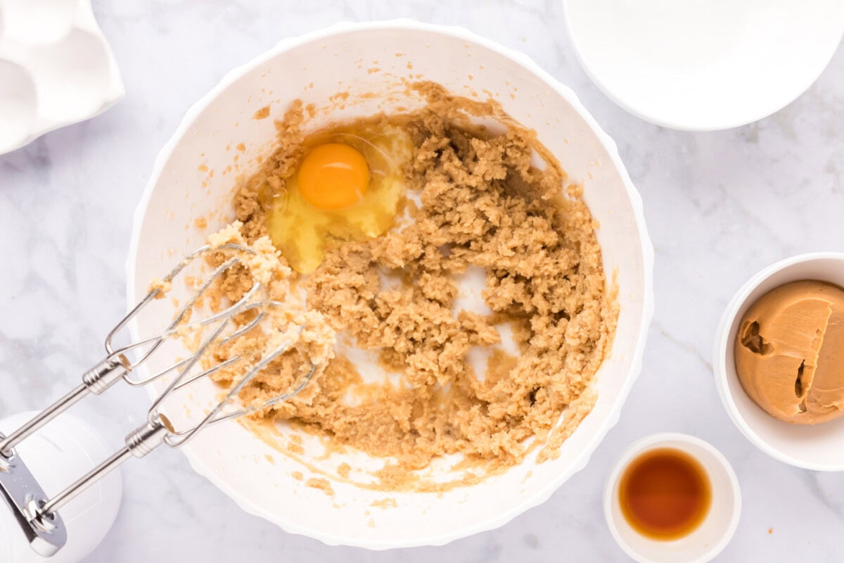 mixing peanut butter cookie dough ingredients in a bowl