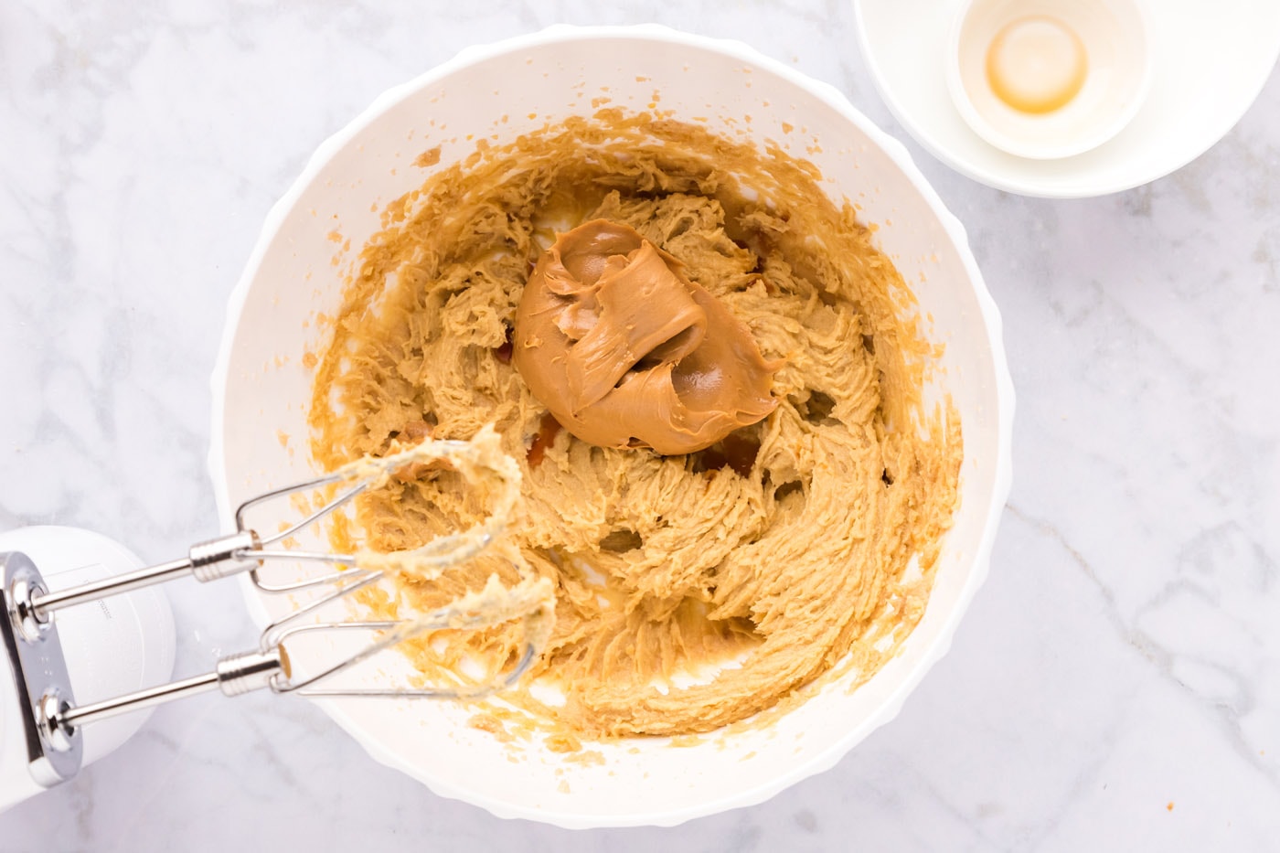 adding peanut butter to cookie dough