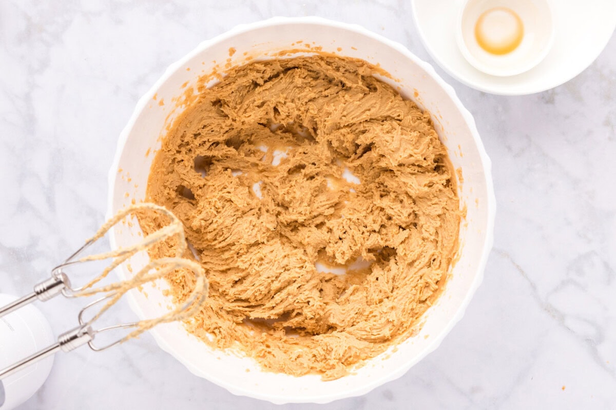 mixer incorporating ingredients for peanut butter cookies