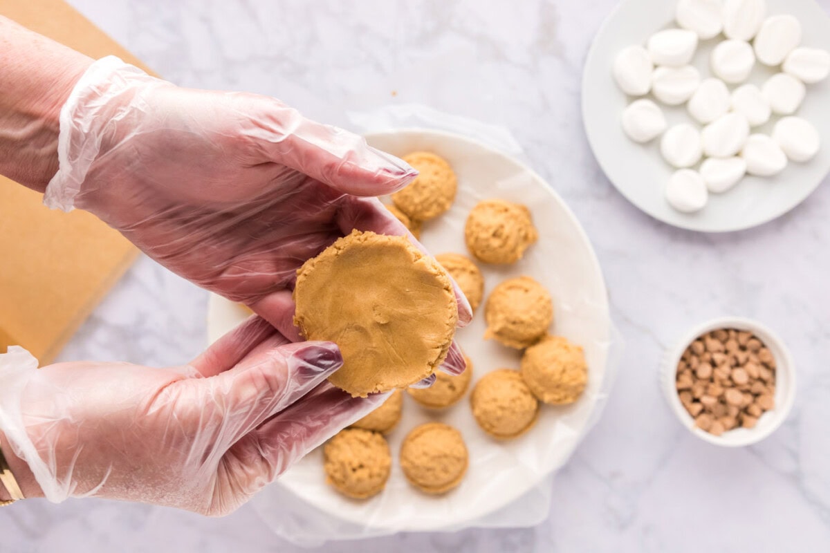 flattening a peanut butter cookie ball