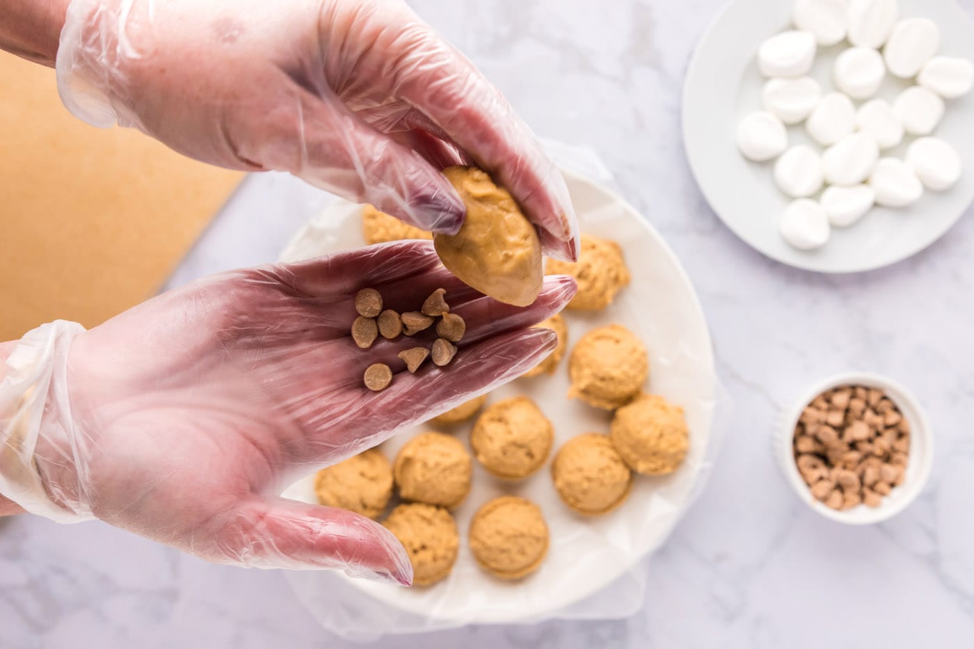 pressing peanut butter cookie ball into peanut butter chips