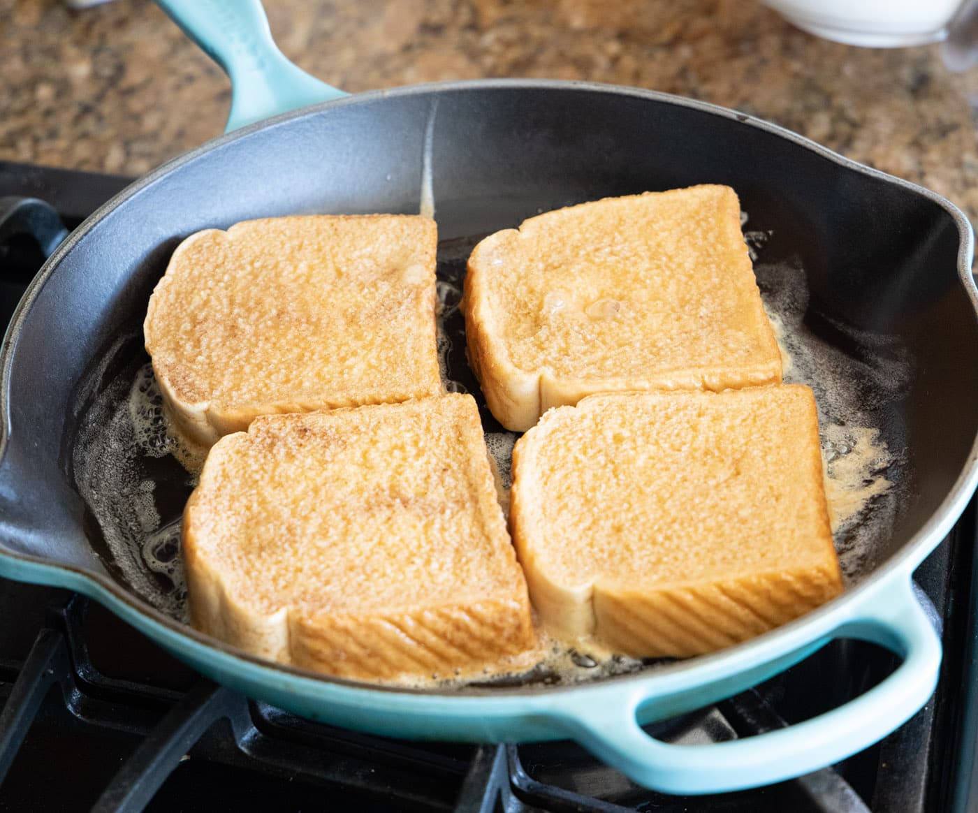 cooking french toast slices in a skillet