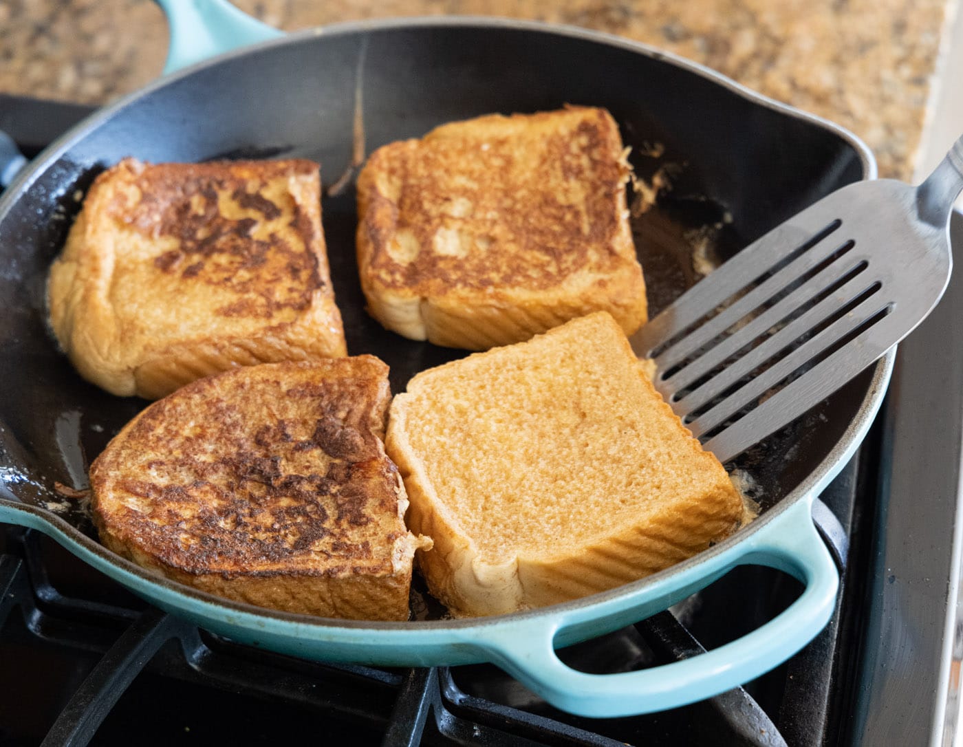 flipping french toast slices in a skillet