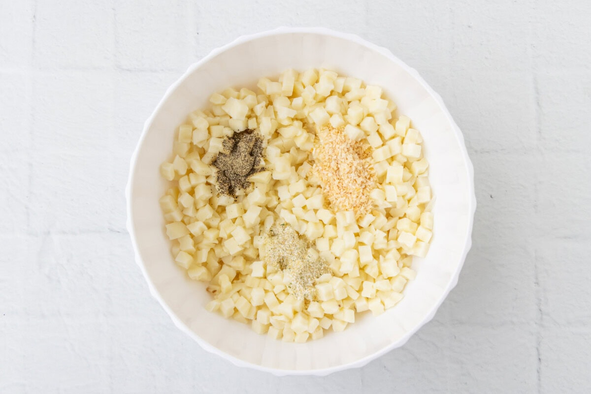 diced potatoes with seasonings in a bowl