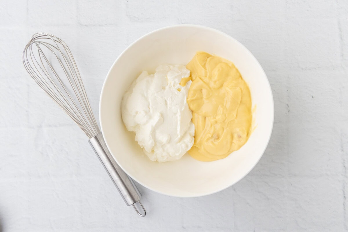 cream of chicken soup and sour cream in a bowl