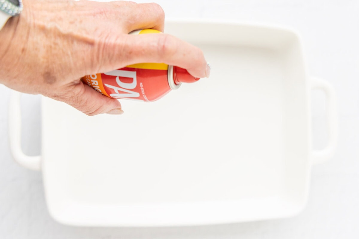 spraying baking pan with non stick spray